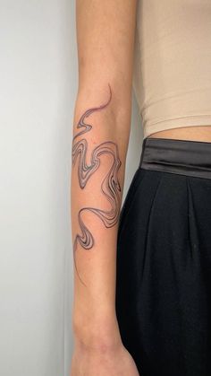 a woman's arm with a tattoo on the left side of her right arm