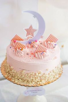 a birthday cake with pink frosting and stars on top