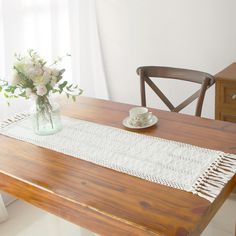 a wooden table topped with a vase filled with flowers