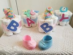 baby shower items on a table with the letters spelled out