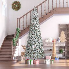 a decorated christmas tree in front of a staircase