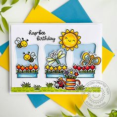 a handmade birthday card with flowers, bees and sunflowers on the side