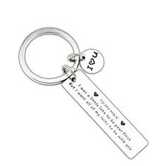 a keychain with two hearts on it and the words love are written in cursive writing