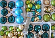 many different colored ornaments in boxes on display