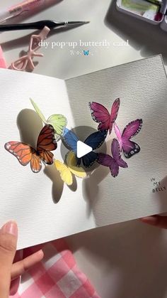 a person holding a card with three butterflies on it and the caption says, day pop - up butterfly card