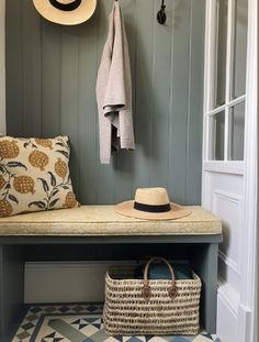 a bench with a hat on it next to a coat rack