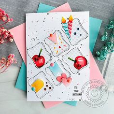 a birthday card with an apple, cake and cherries on it next to some flowers