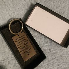 a keychain with a quote on it sitting next to a card box that says, any year has been passed