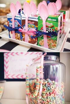 candy bar with pink spoons, cereal bars and other treats in glass containers on a table