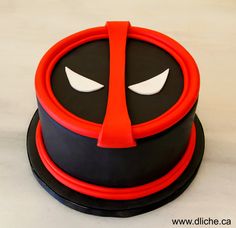 there is a cake that has been decorated to look like deadpool on it's face