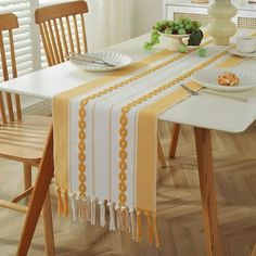 a dining room table with plates and bowls on it