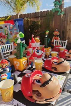 a table with mario bros themed plates and cups on it