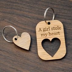 two wooden keychains with the words, a girl stole my heart on them