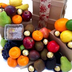 an assortment of fruit and chocolates in boxes