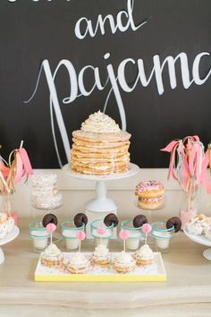 desserts and pastries are displayed on a table