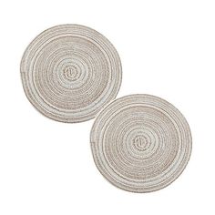 two round rugs on top of each other, one is white and the other is beige