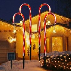 lighted candy canes in front of a house