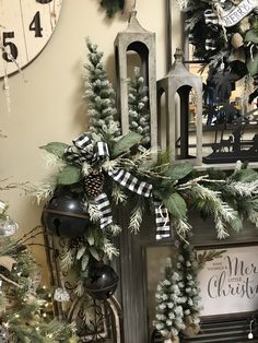 a christmas mantle decorated with greenery, pine cones and evergreens in front of a clock