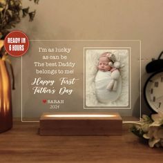 a glass photo frame with a baby's first father's day message on it