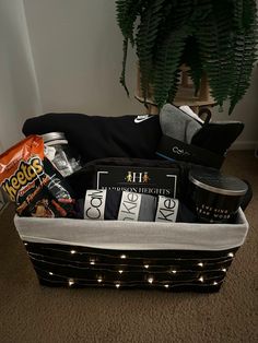 a basket filled with snacks and drinks on the floor