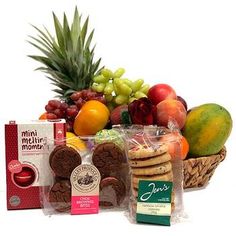 a basket filled with lots of different types of fruit and snacks on top of each other