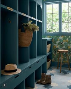 a room that has some shelves in it and a hat hanging on the wall next to them