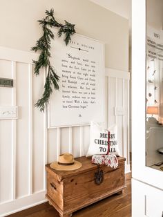 a wooden trunk sitting on top of a hard wood floor next to a white wall