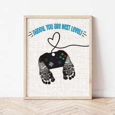 Father's Day Footprint Art | Gamer Dad Gifts | Ollie + Hank Gamer Fathers Day Gifts From Kids, Diy Gifts For Dad From Baby, Father’s Day Footprint, Diy Grandpa Birthday Gifts, Dads First Birthday Gift From Baby, Father’s Day Canvas Crafts, Father’s Day Canvas, Diy Father’s Day Footprint, Gamer Dad Gifts Father's Day