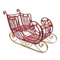 a red and gold metal sleigh sitting on top of a white background