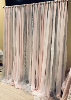 pink and grey sheer curtains hanging on a wall