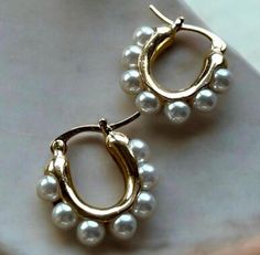 Put an elegant twist on the classic gold hoops.  Our Gold Plated Hoop Earrings adorned with Pearls - a fusion of classic charm and contemporary flair. Elevate your style with this exquisite pair that seamlessly merges the timeless appeal of pearls with the ever-popular gold hoop. Each hoop is delicately embellished with pearls, creating a sophisticated and luxurious aesthetic. Materials: Gold Plated Stainless Steel. Waterproof. Tarnish free. Hypoallergenic. Our stainless steel jewelry is made wi Jewelry Classy, Pearl Earrings Gold, Luxurious Aesthetic, Hoops Gold, Gold Pearl Earrings, Classy Jewelry, Earrings Pearl, Classic Gold, Gold Hoops