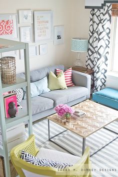 a living room filled with furniture and pictures on the wall