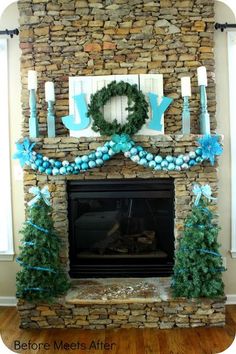 a fireplace decorated for christmas with blue decorations and white candles on the mantels