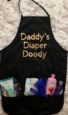 a black apron with the words daddy's diaper doody written on it