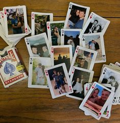 several playing cards with pictures of people on them sitting on top of a wooden table