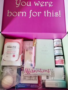 a pink box filled with personal care items and writing on the side that says, you were born for this