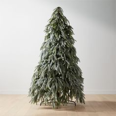 a small fir tree on a wooden floor