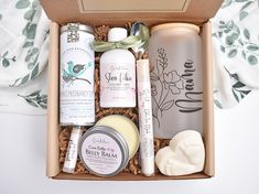 an open gift box containing personal care products and handmade soaps on a bed