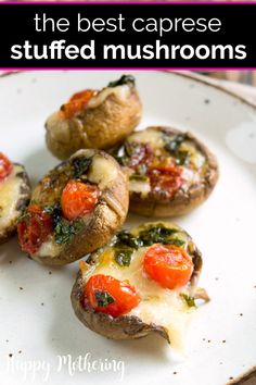 the best caprese stuffed mushrooms with tomatoes and spinach are on a white plate