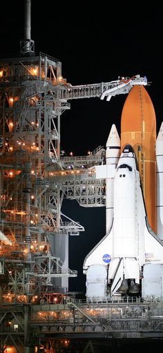 the space shuttle is on display at night