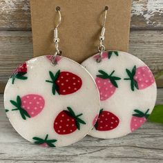 pair of earrings with strawberry print on them