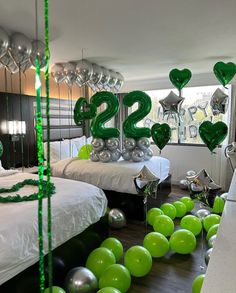 balloons and streamers in the shape of numbers on a bed