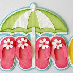 the word summer is decorated with flip flops and an umbrella