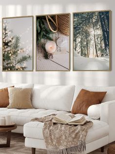 a living room with white furniture and christmas decorations on the wall above it is a coffee table