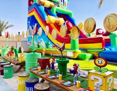 an inflatable slide and other toys are on display at a children's birthday party