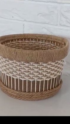 a woven basket sitting on top of a white table