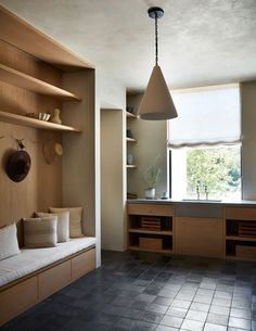 a living room filled with furniture and lots of shelves next to a kitchen counter top