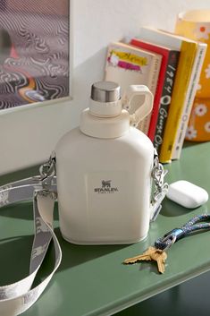 a white flask bottle sitting on top of a green counter