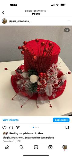 a red hat with silver decorations and bows on it's head is displayed for the camera