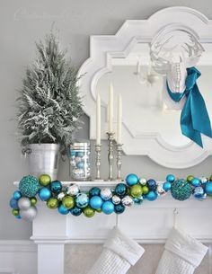 a fireplace decorated for christmas with stockings and ornaments